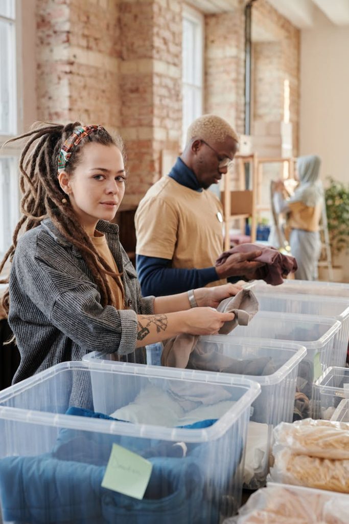 Mastering the First Impression: Your intriguing post title goes here Diverse group of volunteers sorting donated clothes at an indoor center.
